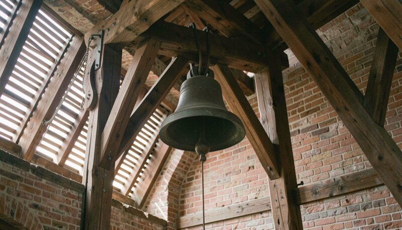 Slatted louvers let the sound out of a bell chamber while the timber frame carries the weight of the bell.